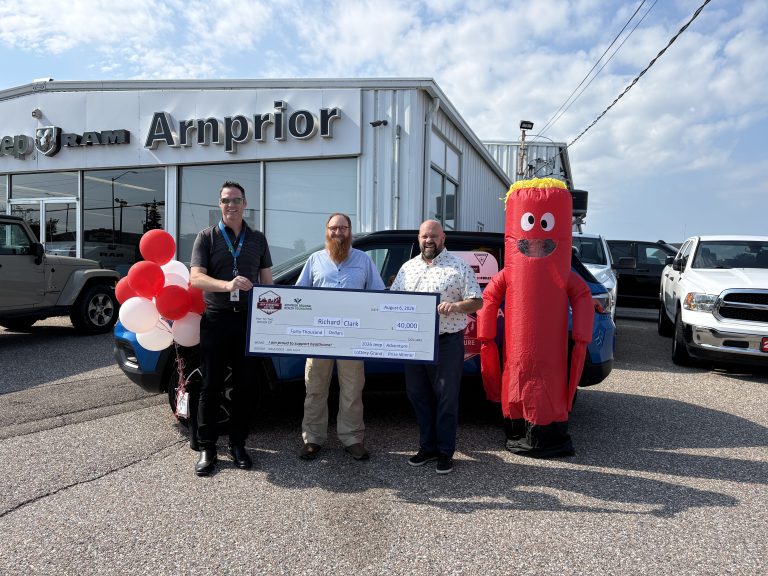 From left to right: Executive Director of the Arnprior Regional Health Foundation Ben Gardiner, Grand Prize winner Richard Clark, Arnprior Chrysler owner Mike Mulder